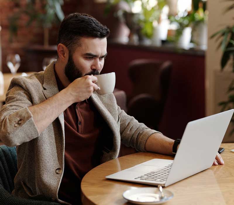 Solopreneur working on a laptop in a café
